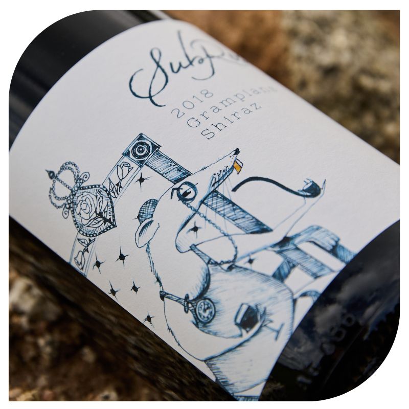 bottle of the subrosa 2018 grampians shiraz lying on the granite in the grampians wine region